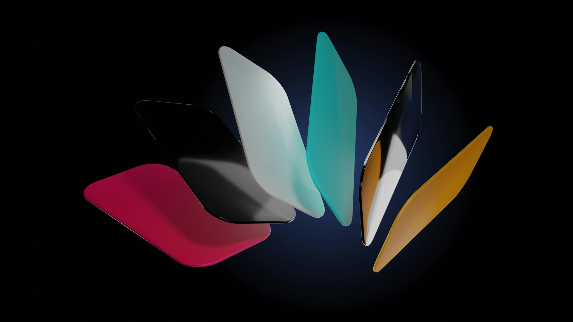 a group of different colored surfboards on a black background